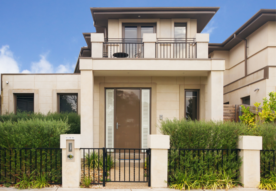 two story townhouse with gate and fence